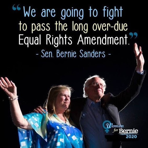 Bernie Sanders and his wife wave to a crowd beneath the words "We are going to fight to pass the long overdue Equal Rights Amendment."