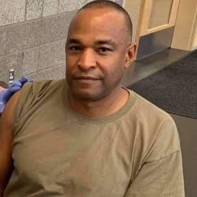 Headshot of African American male in tan t-shirt.
